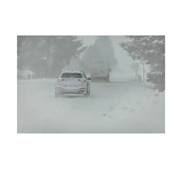 Yellow weather warning car car driving in snowy conditions